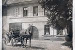 Great-Great-Grandfather Carl, around 1910, his wife and their daughters are looking out the windows